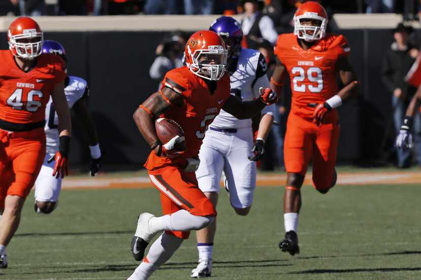 Oklahoma State's Josh Stewart (5) returns a punt for a touchdown against TCU in the first...