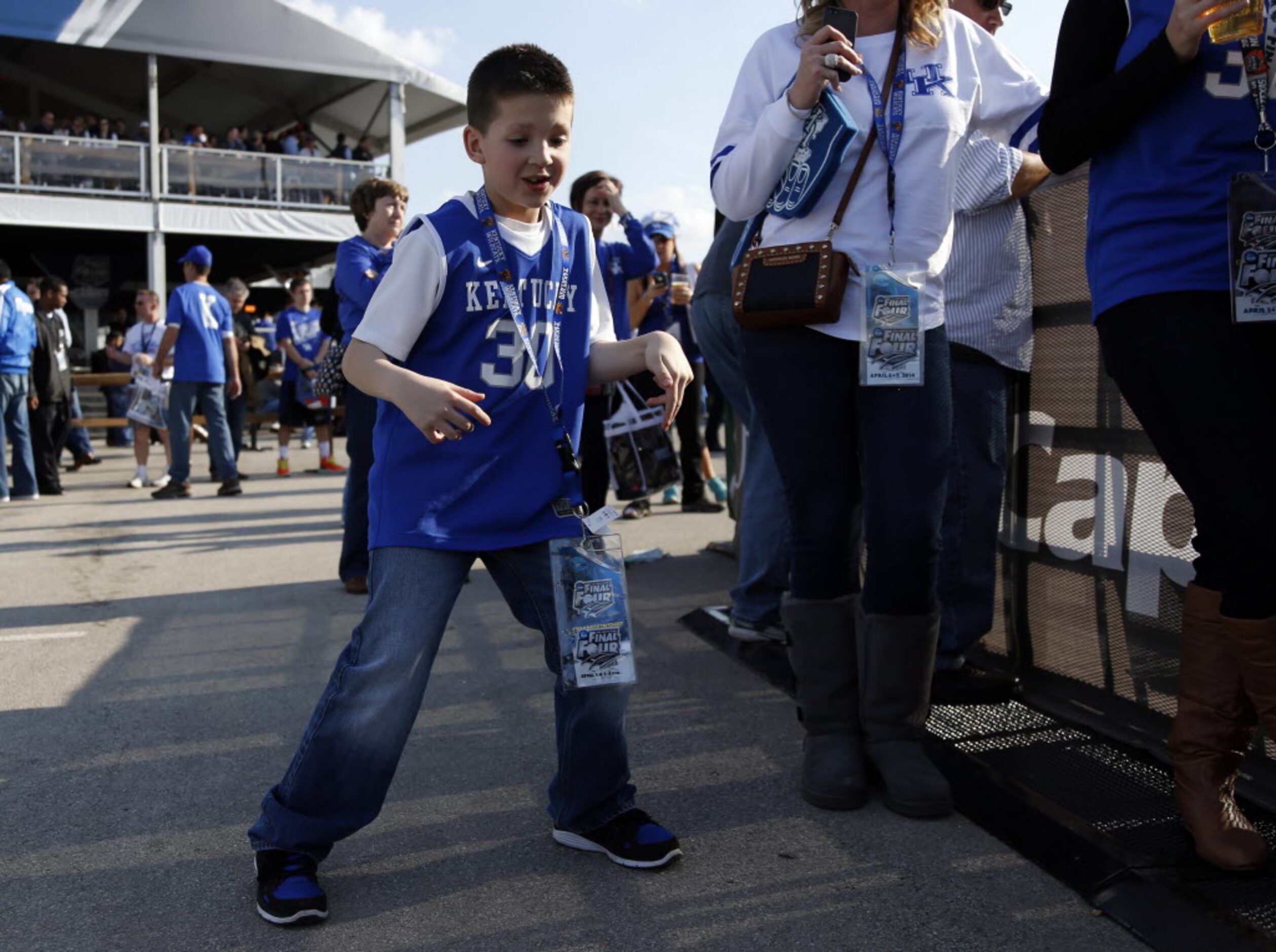 Reece Thomas, 8 of Evansville, Indiana dances to the music at the Tip-Off Tailgate party...