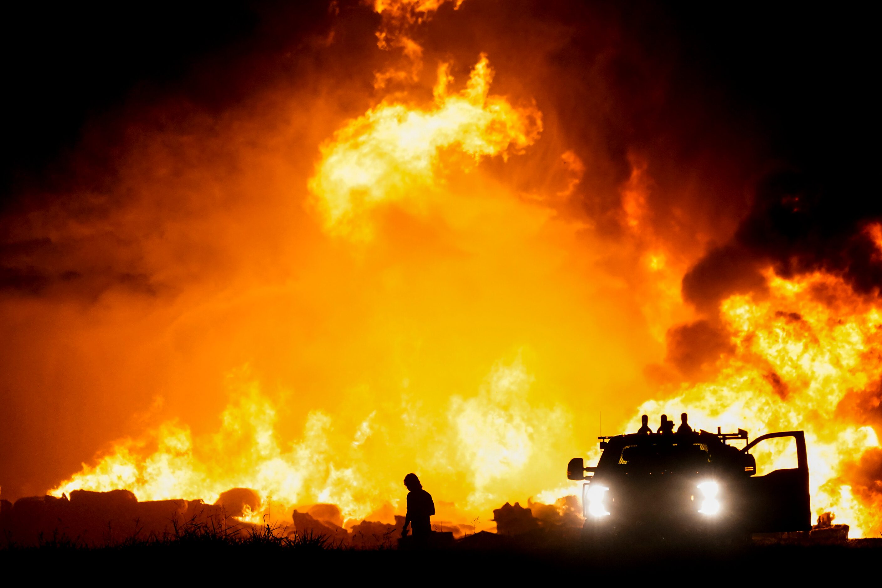 Fire crews battle a massive blaze in an industrial area of Grand Prairie, Texas, in the...