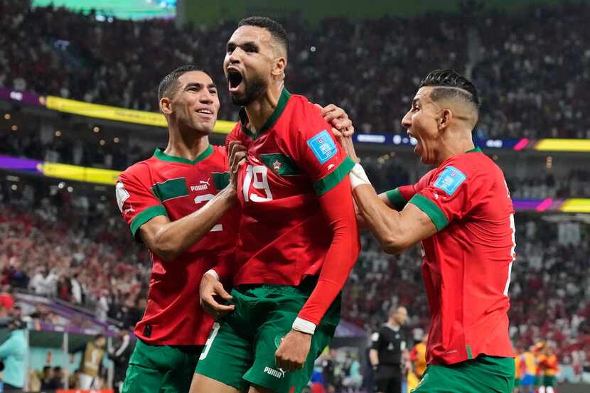 Morocco's Youssef En-Nesyri, center, celebrates after scoring his side's first goal during...