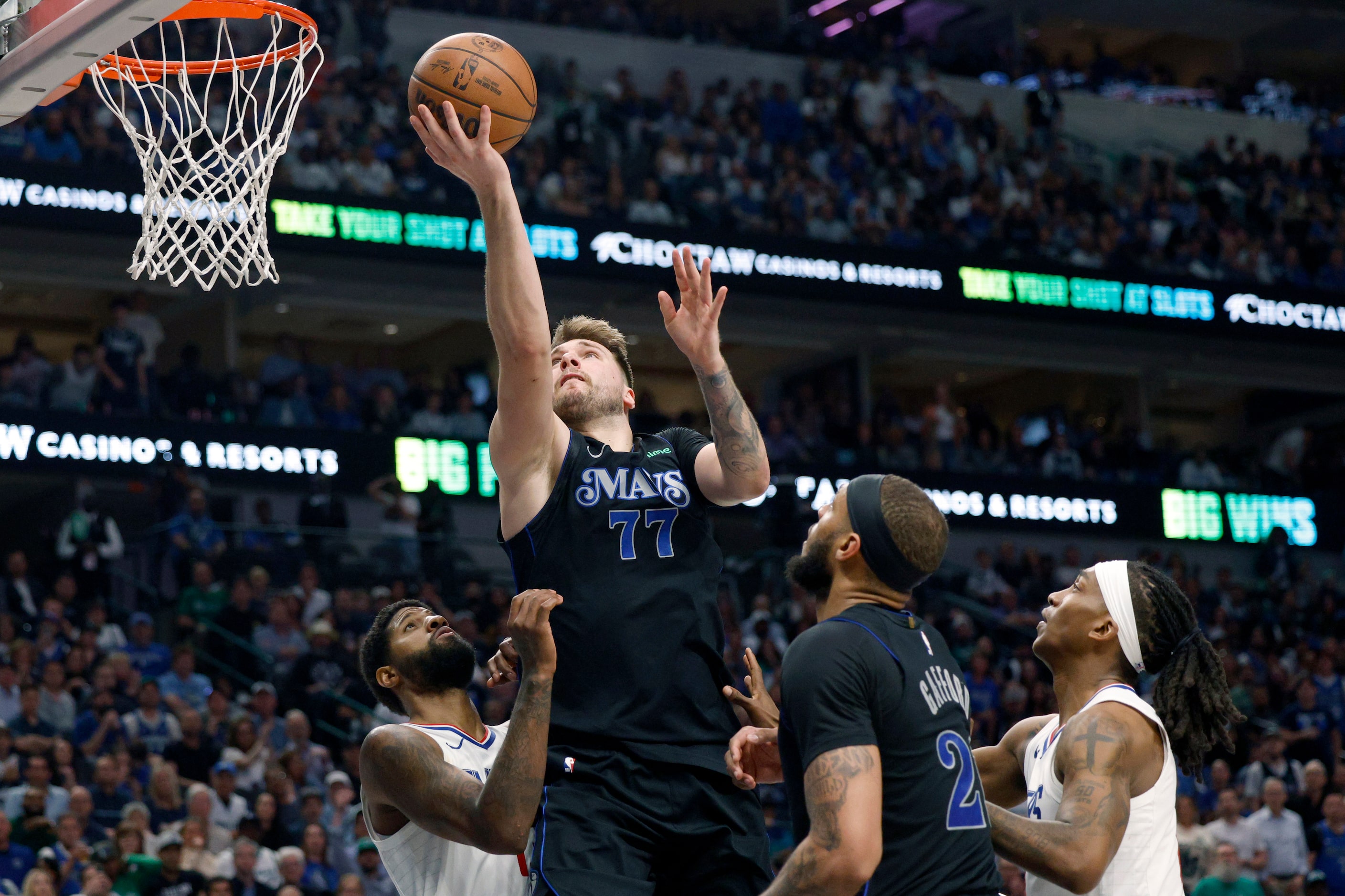 Dallas Mavericks guard Luka Doncic (77) attempts a layup against LA Clippers forward Paul...