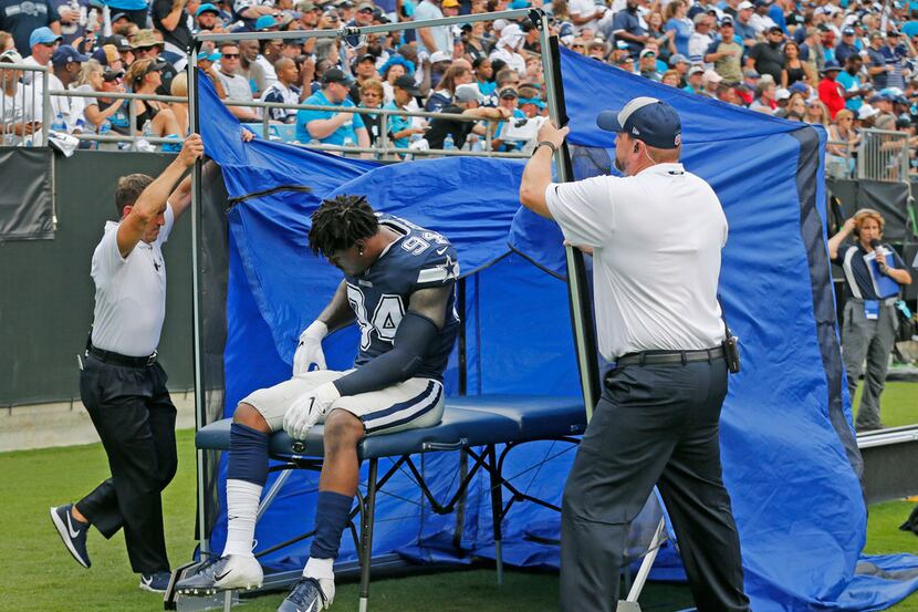 Dallas Cowboys defensive end Randy Gregory (94) goes under the tent to look at an injury in...
