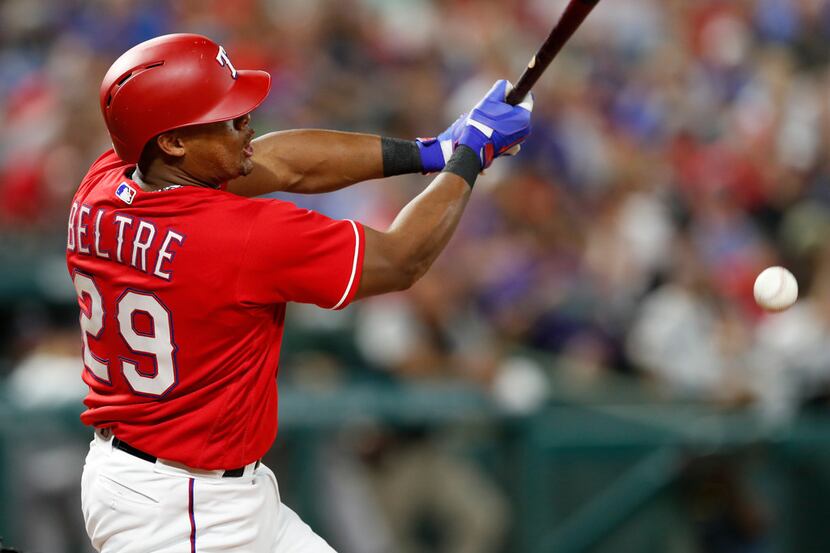 Texas Rangers' Adrian Beltre follows through on his infield single against the Colorado...