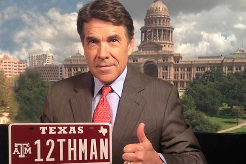 Texas Gov. Rick Perry shows off the Texas A&M "12THMAN" license plate sold at auction last...