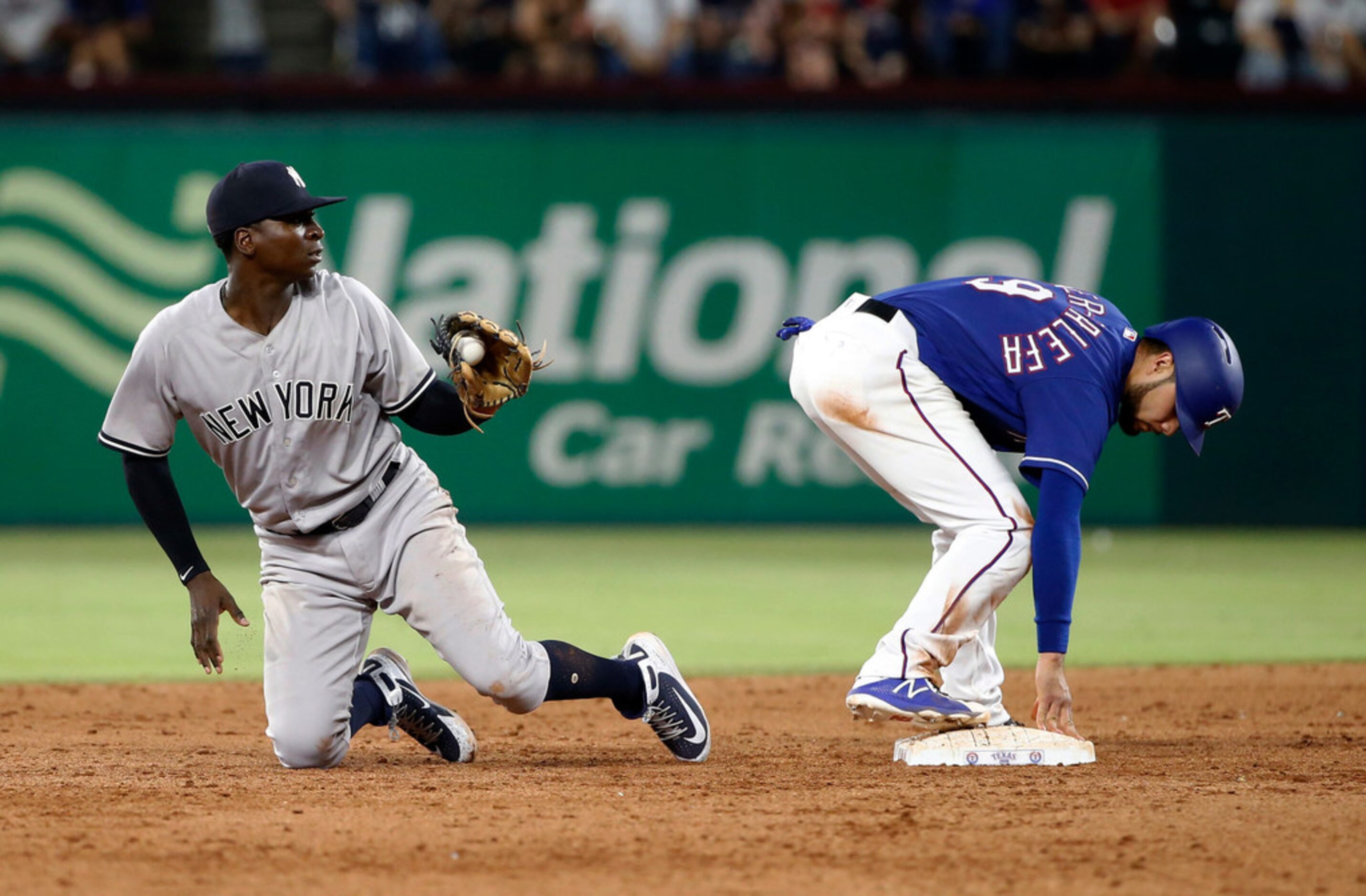 Texas Rangers Isiah Kiner-Falefa (9) stands safely on second base after a steal, as New York...