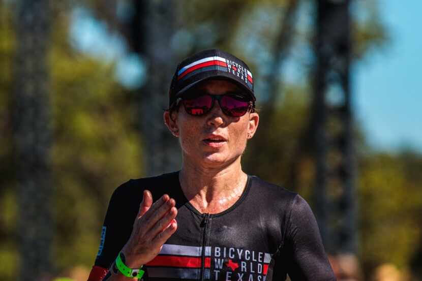 Brandi Grissom Swicegood blows a kiss to her husband and daughter during the run portion of...