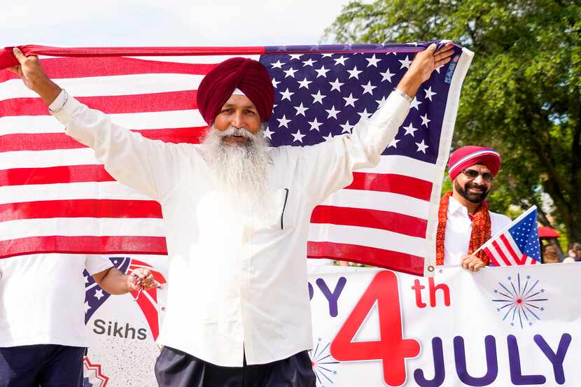 A group representing the Sikh Community of North Texas marches in the Arlington Independence...