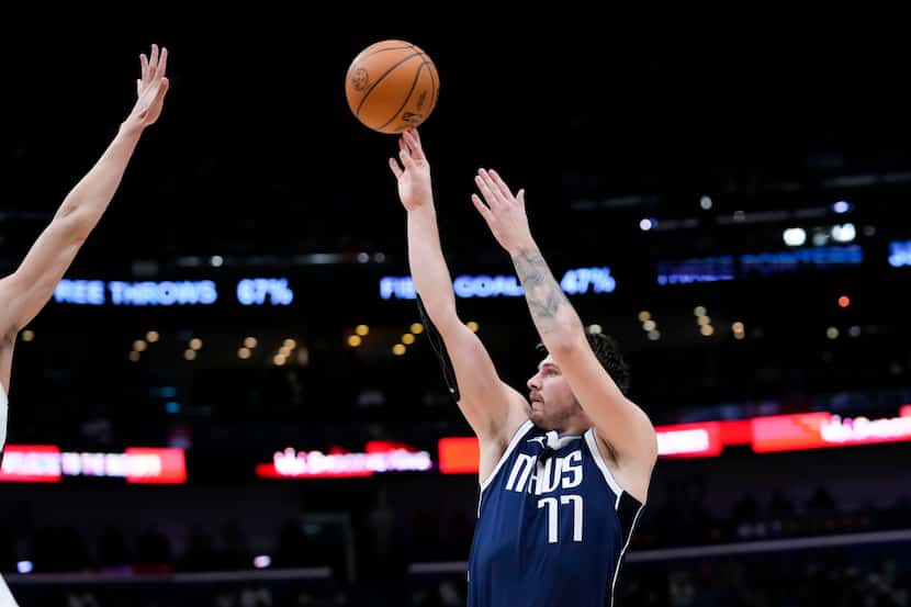 Dallas Mavericks guard Luka Doncic (77) shoots in the second half of an NBA basketball game...