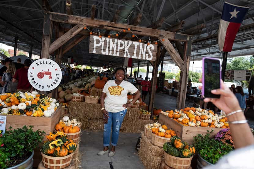 Monique Brumsey poses for a photo with pumpkins at the Dallas Pumpkin Patch during the...