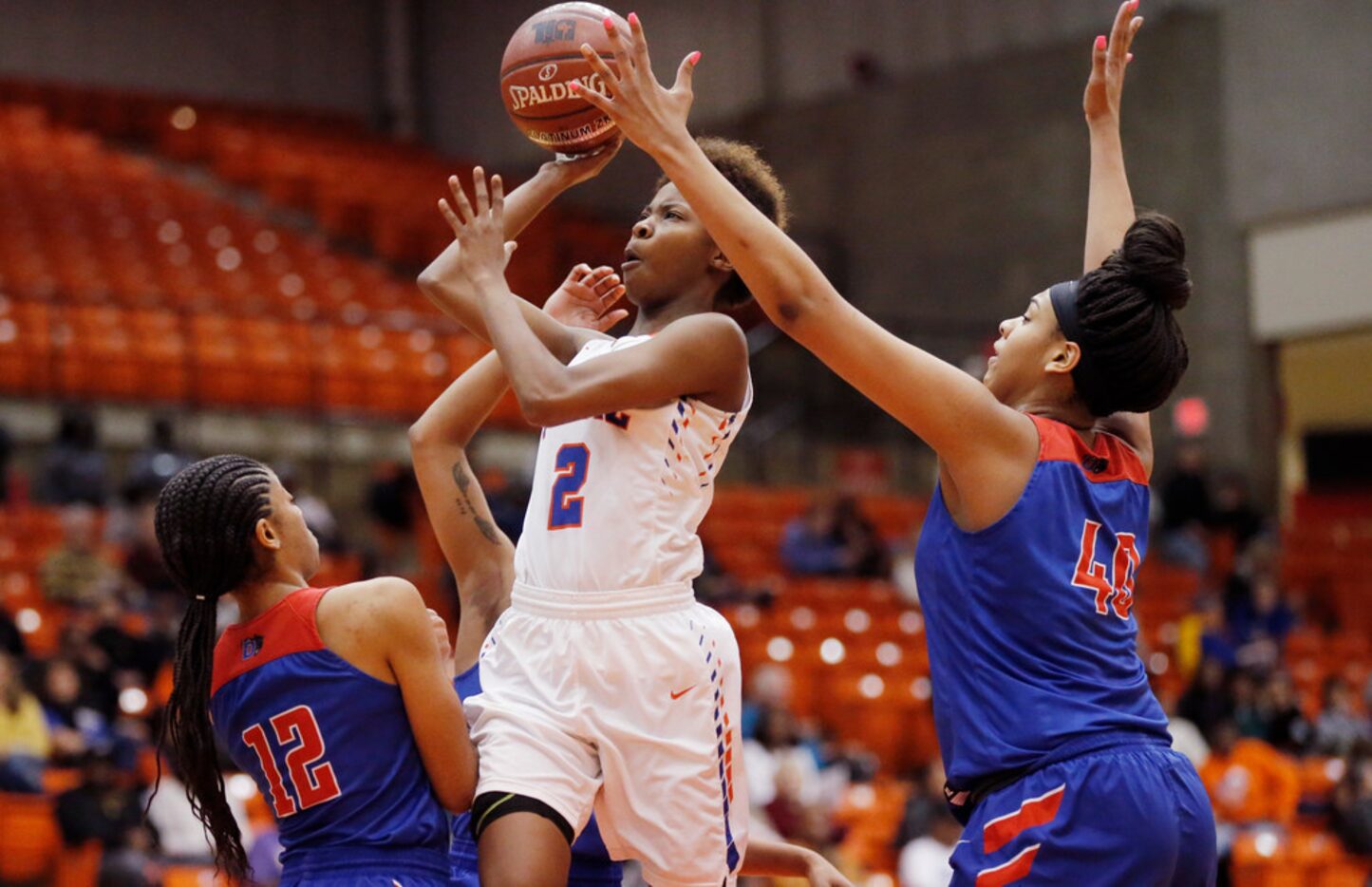 Arlington Bowie junior guard Malay McQueen (2)  attempts a shot as Duncanville junior guard...