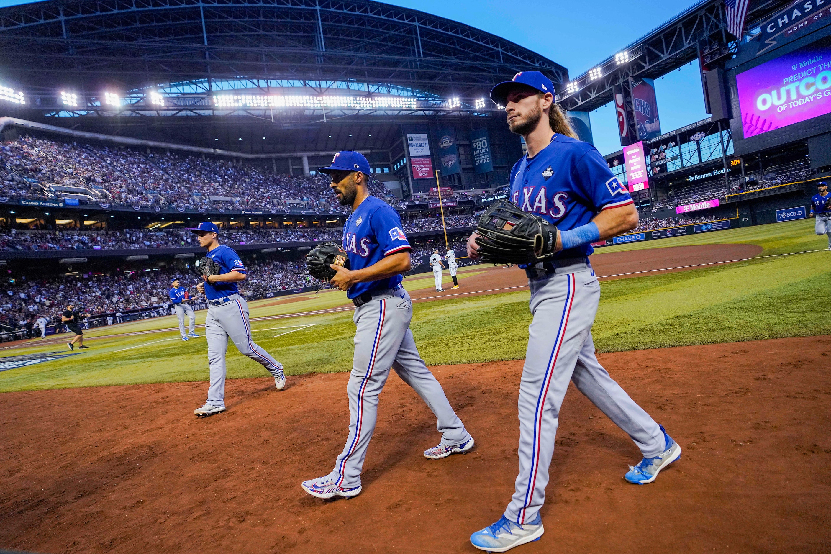 Texas Rangers left fielder Travis Jankowski (front) second baseman Marcus Semien (center)...