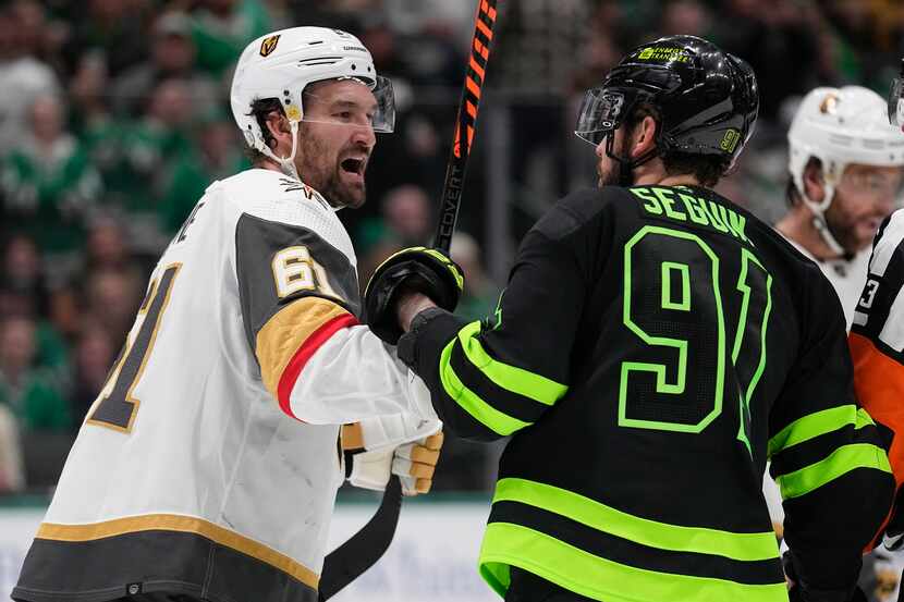 Vegas Golden Knights right wing Mark Stone, left, and Dallas Stars center Tyler Seguin argue...