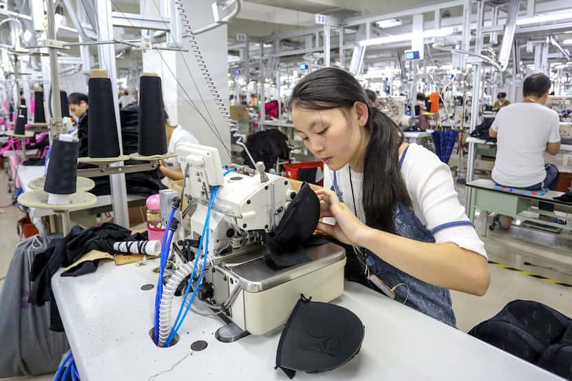 This photo taken on August 2, 2018 shows workers at a swimwear factory in Yinglin town in...