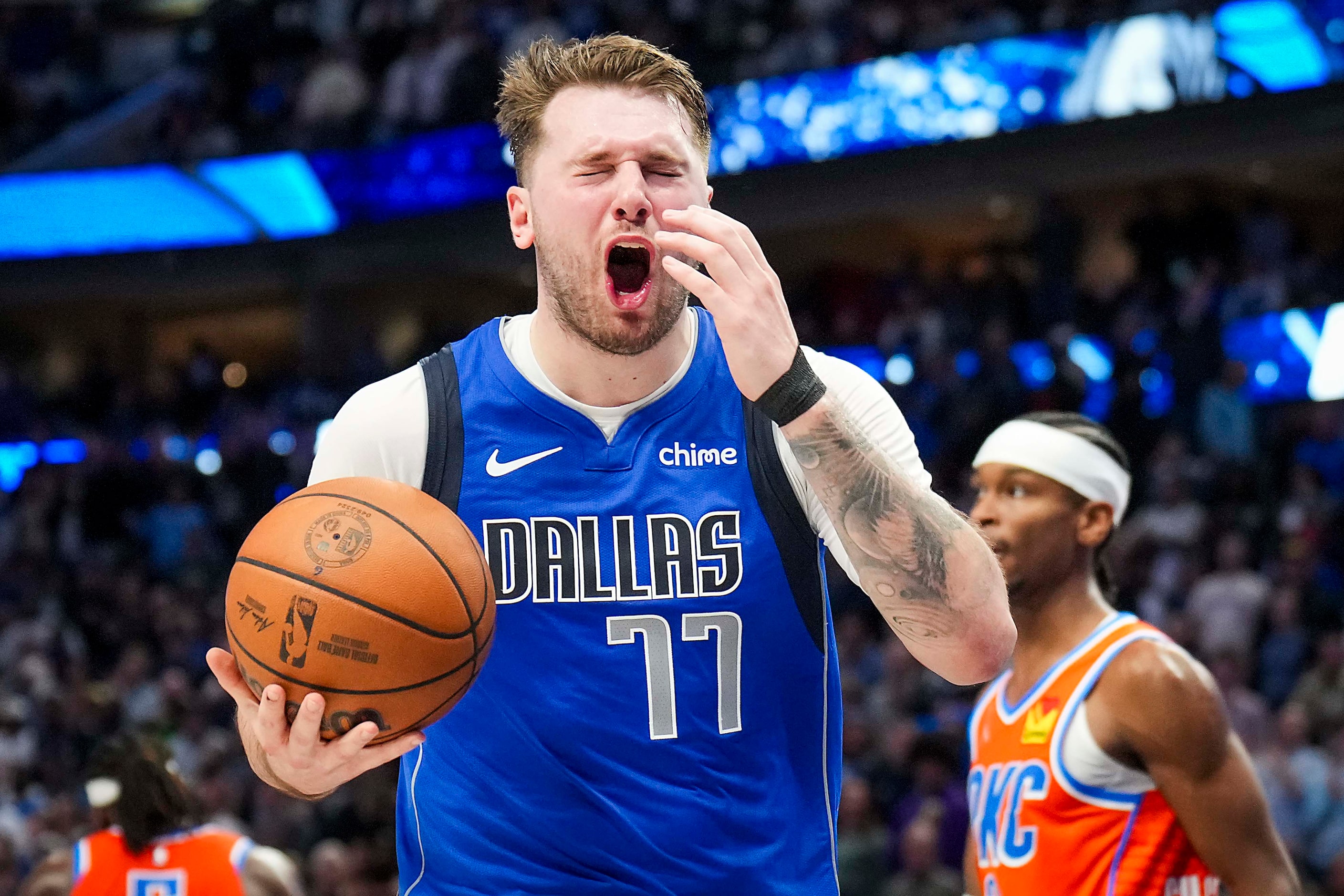 Dallas Mavericks guard Luka Doncic reacts after being called for traveling with 1:27 left in...