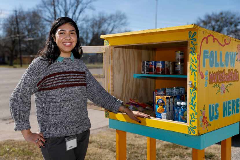 Marah Suarez pictured with community food pantry she founded, Maria's Bodeguita, in Dallas,...