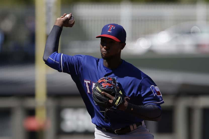 Texas Rangers' Jurickson Profar throws during a spring exhibition baseball game against the...