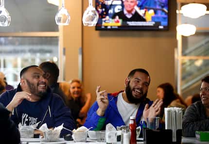 David Cortez (left) and Adrian Gonzales dine at the bar at Wahlburgers on opening day in...