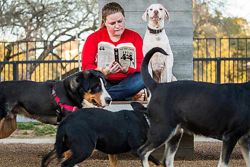  Tracy Cox reads a book as she visits the Johnny Steele Dog Park in Buffalo Bayou Park with...