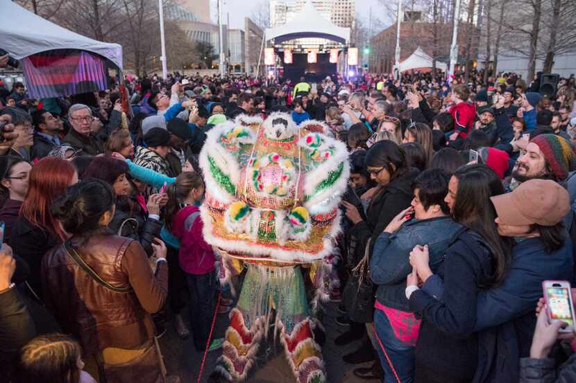 After the lion dance, performers mingle with the audience during the Chinese New Year...