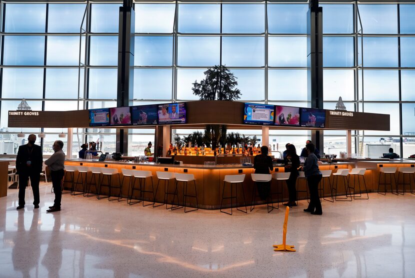 Star Concessions employees work on the Trinity Groves Bar, one of several new...