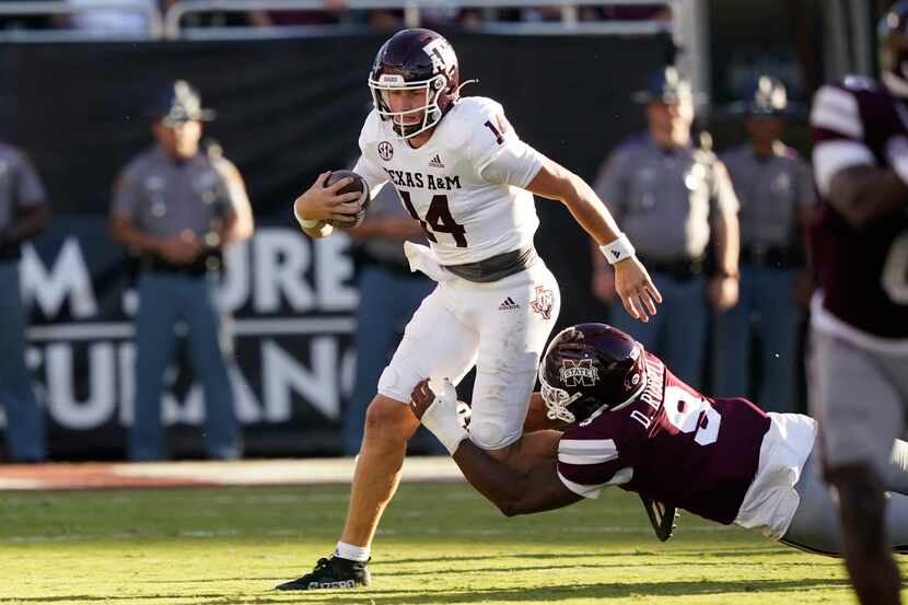 Texas A&M quarterback Max Johnson (14) is tackled by Mississippi State defensive end...