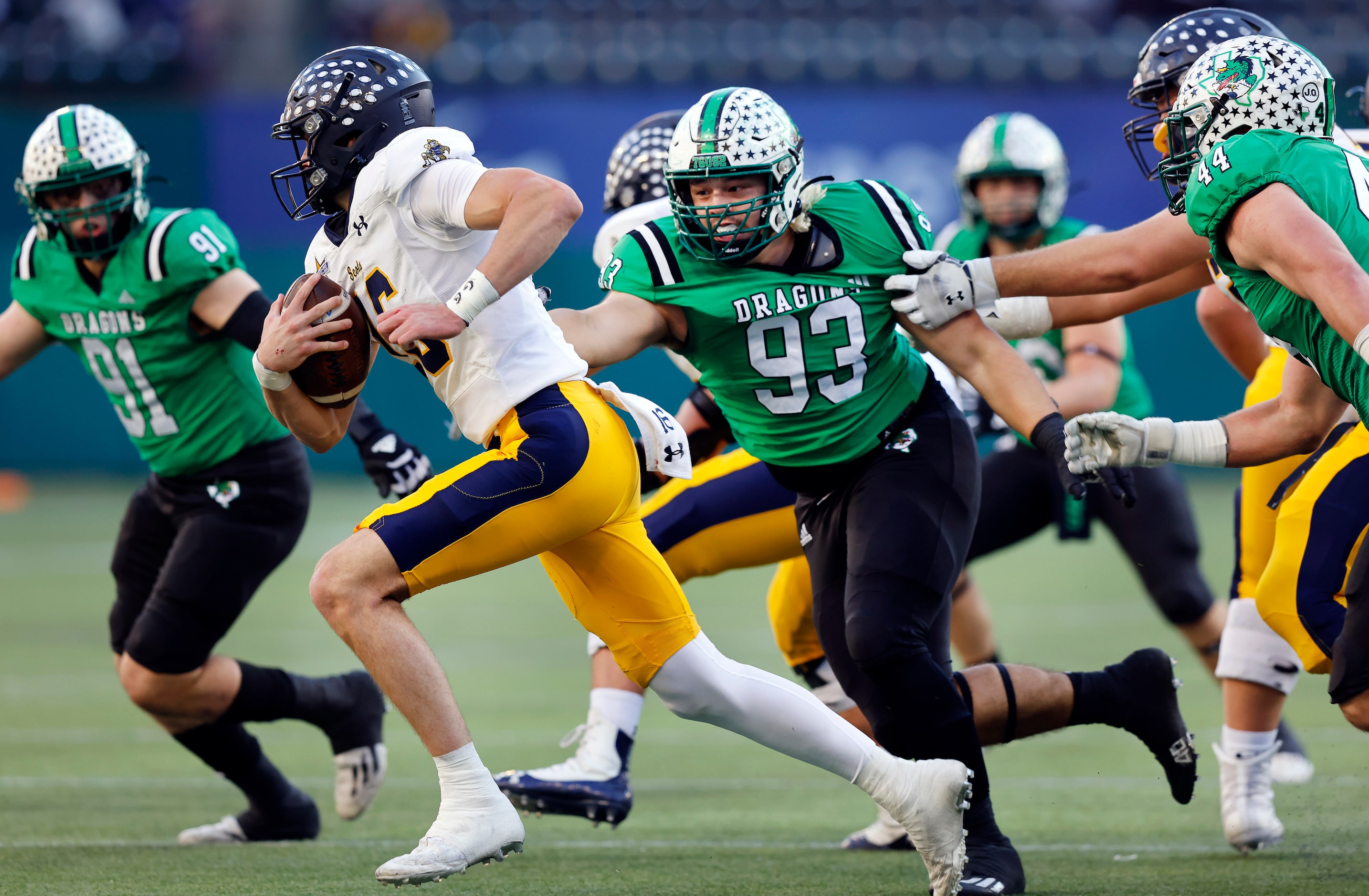 Southlake Carroll defensive end Zac Scarborough
(93) reaches for Highland Park quarterback...