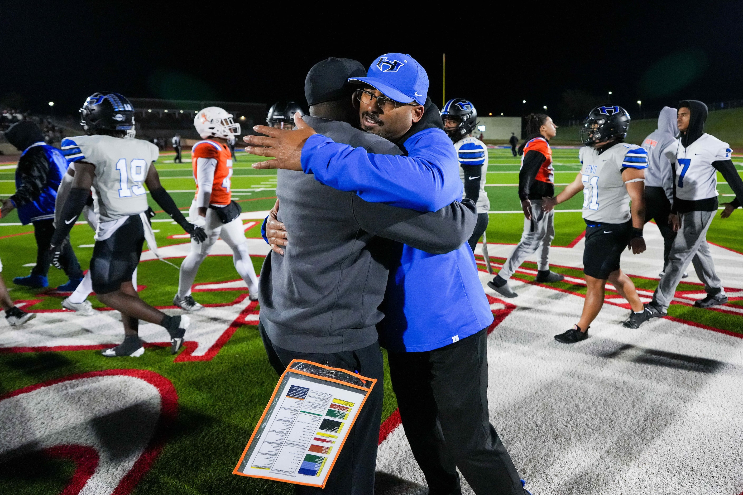 Hebron head coach John Towels hugs Arlington Bowie head coach Joseph Sam after a Class 6A...