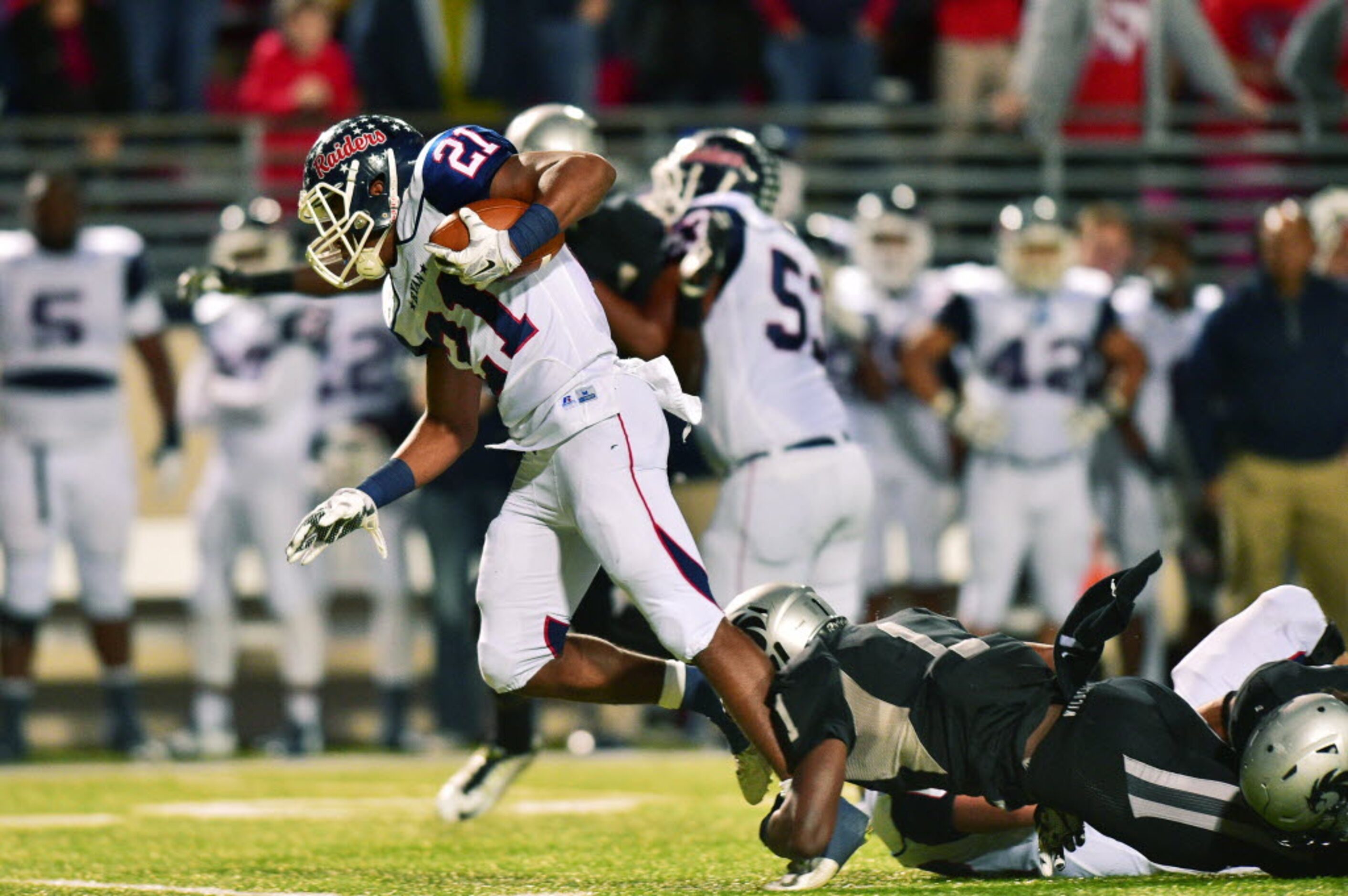 Ryan junior running back Tyreke Davis (21) slips by Guyer junior defensive back Thabo...