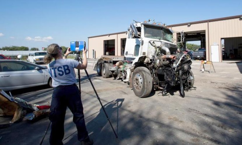 NTSB investigator  Kristin Poland makes a laser scan of the truck that collided with a bus...