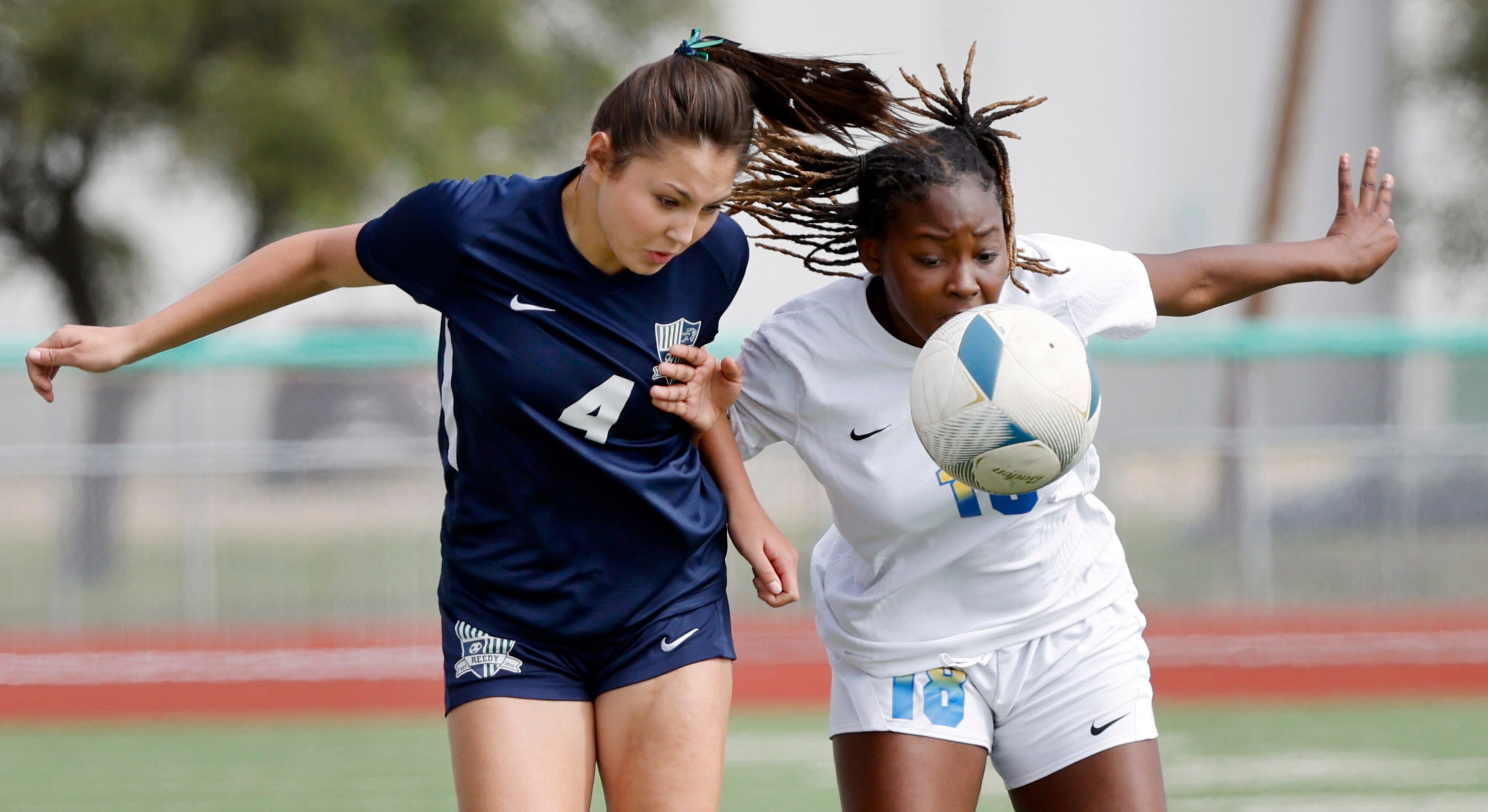 Frisco Reedy’s Naia Rentschler (4) and Frisco’s London Young (18) charge the ball during the...