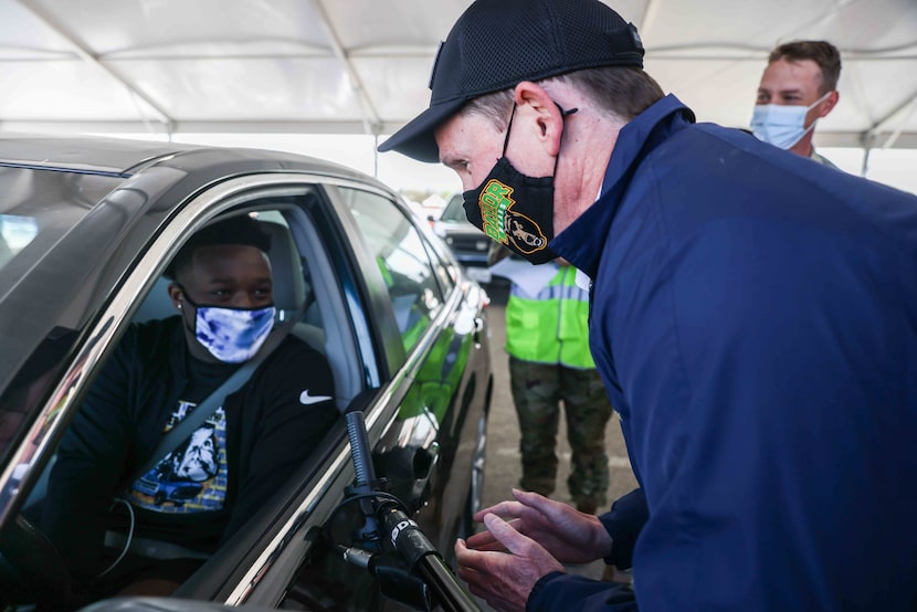 Dallas County Judge Clay Jenkins talked to Quincy Williams, 20, before he received the...