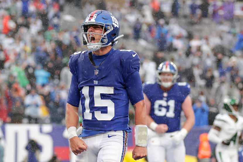 New York Giants quarterback Tommy DeVito (15) runs in the ball for a touchdown during the...
