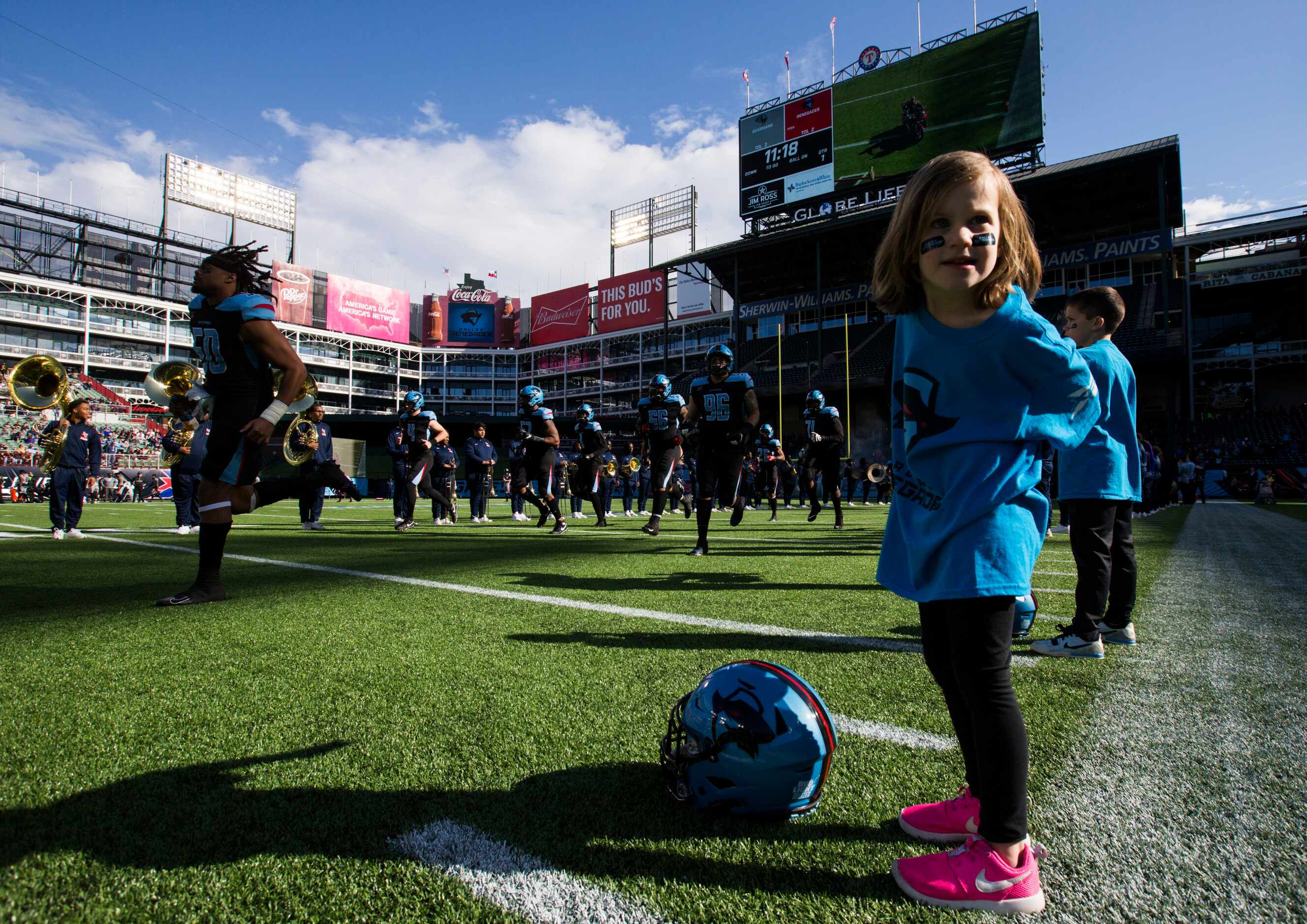 Kendall Kuenzi, 5, stands on the field as the Dallas Renegades enter the stadium before an...