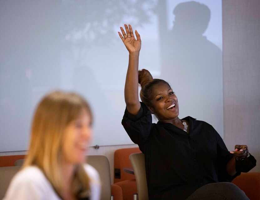 HR manager Erika Jones raises her hand during a monthly company meeting in August.