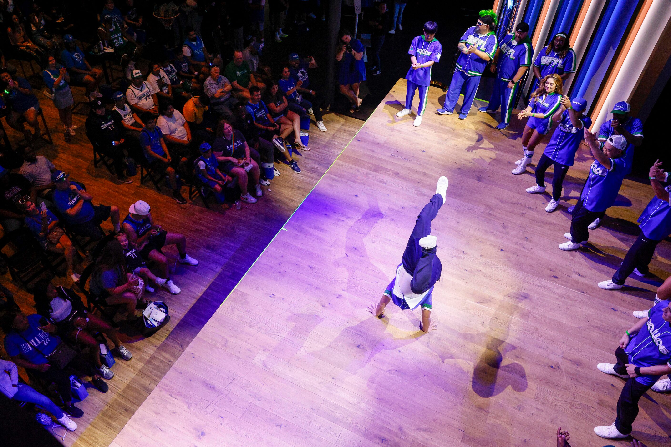 Dallas Mavericks fans watch a performance by the D-Town Crew, Maniaacs and Mavs Breakers...