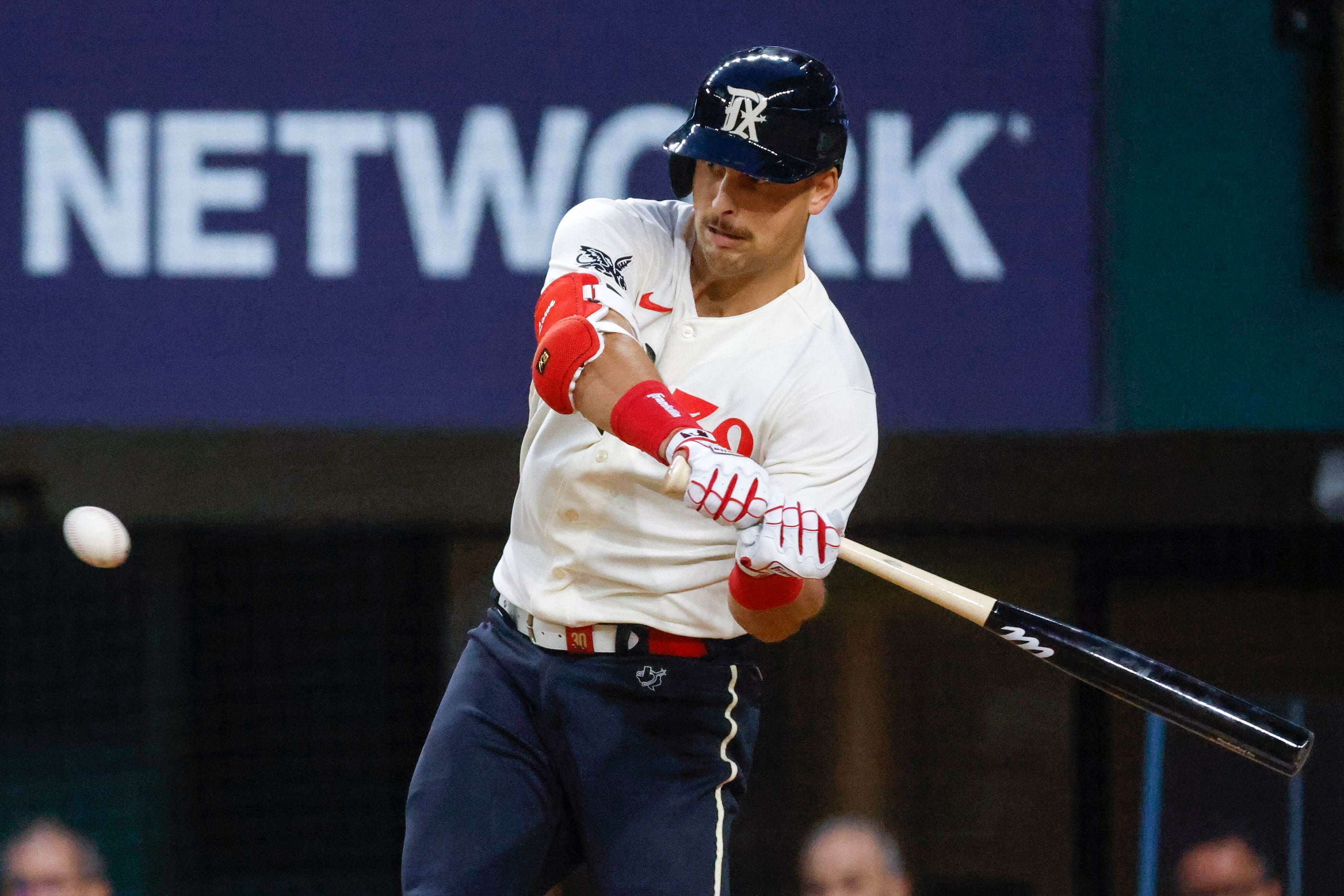 Texas Rangers first baseman Nathaniel Lowe attempts to hit during the third inning of a...