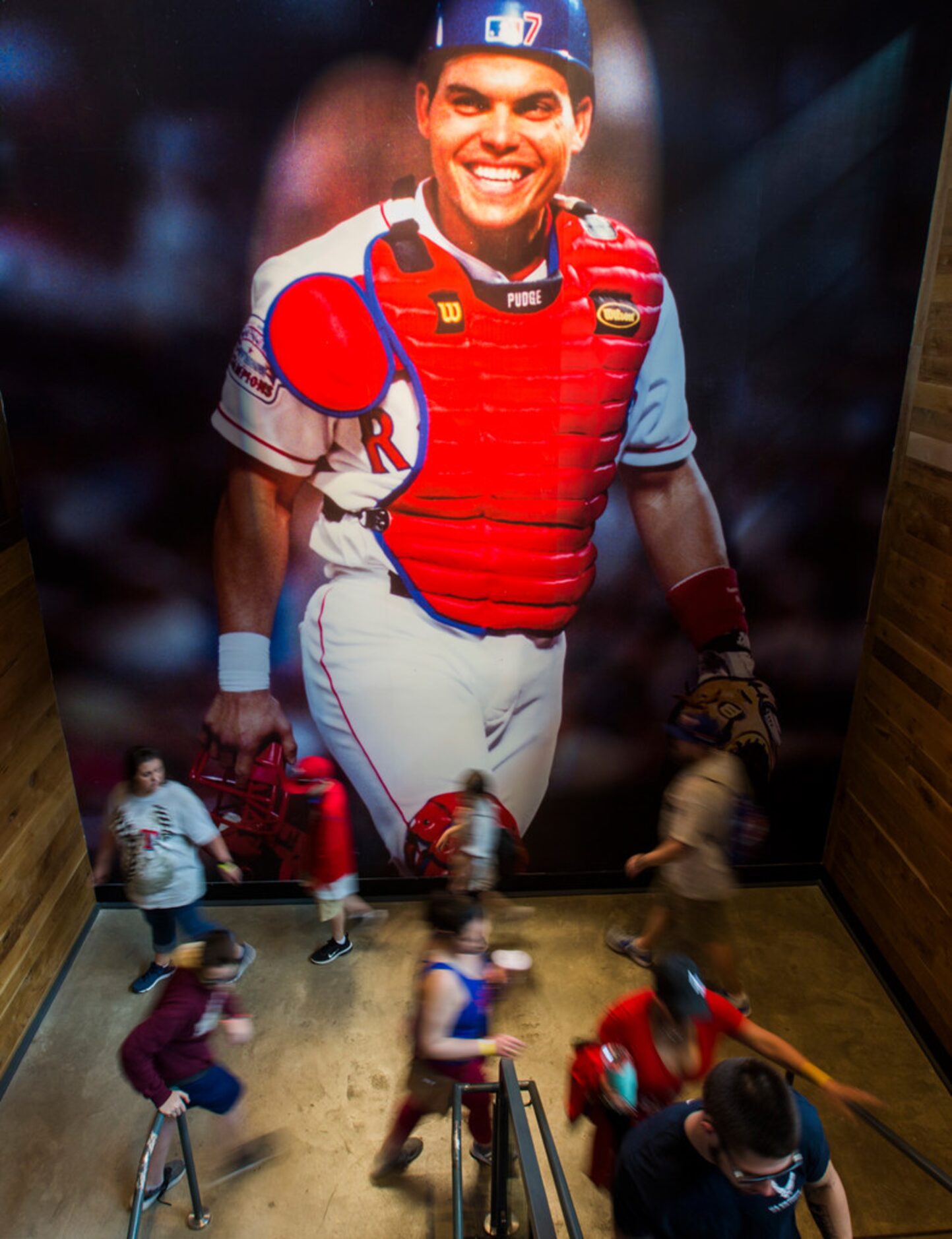 A photo of former Texas Rangers catcher Ivan 'Pudge' Rodriguez hangs on a the wall as fans...