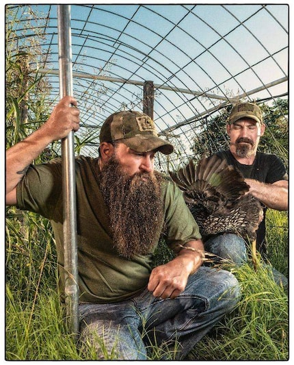 F.A.R.M. co-founders and Army vets James Jeffers and Stephen Smith kneel in grass in a...