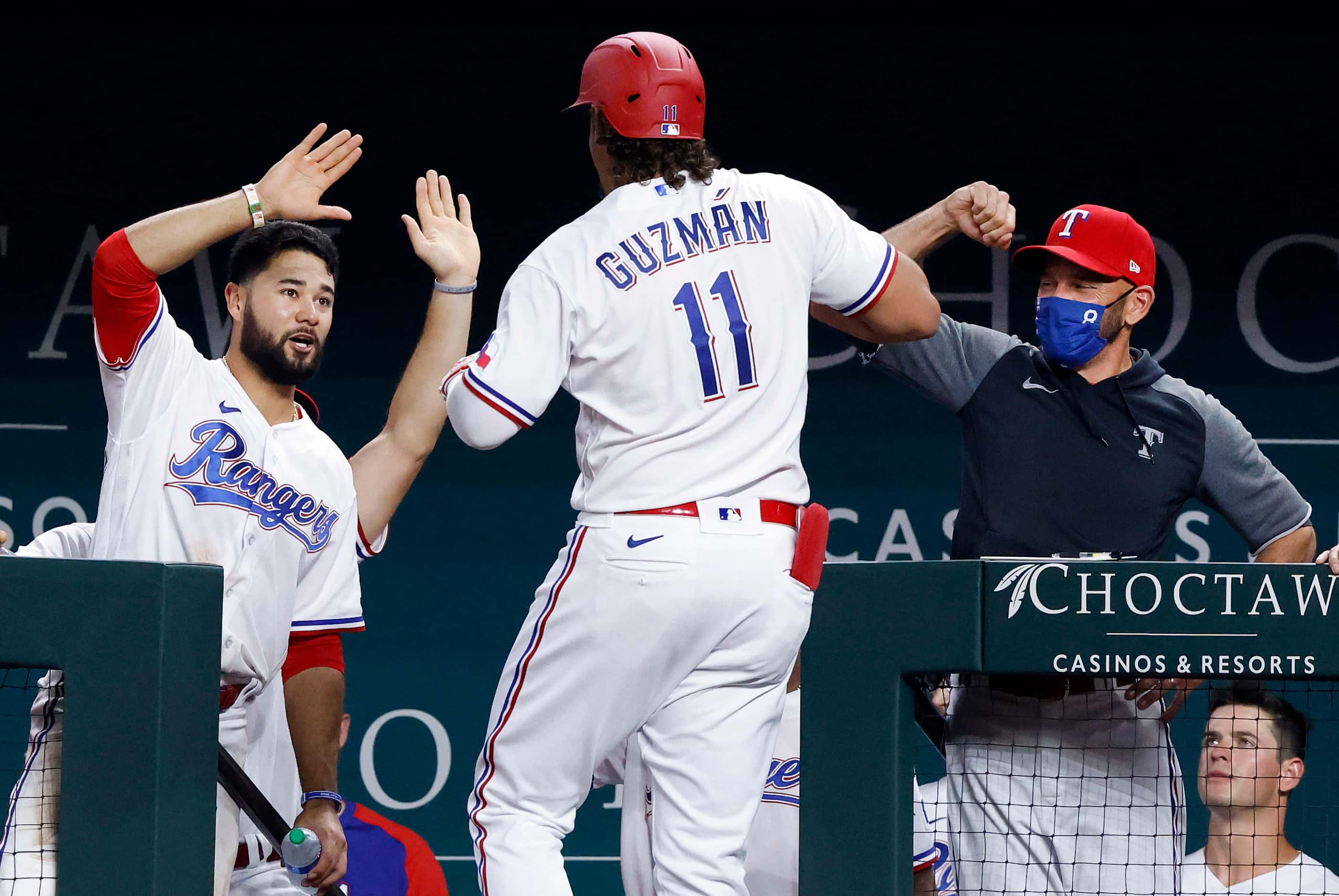 Texas Rangers Ronald Guzman (11) is congratulated on his second inning solo home run against...