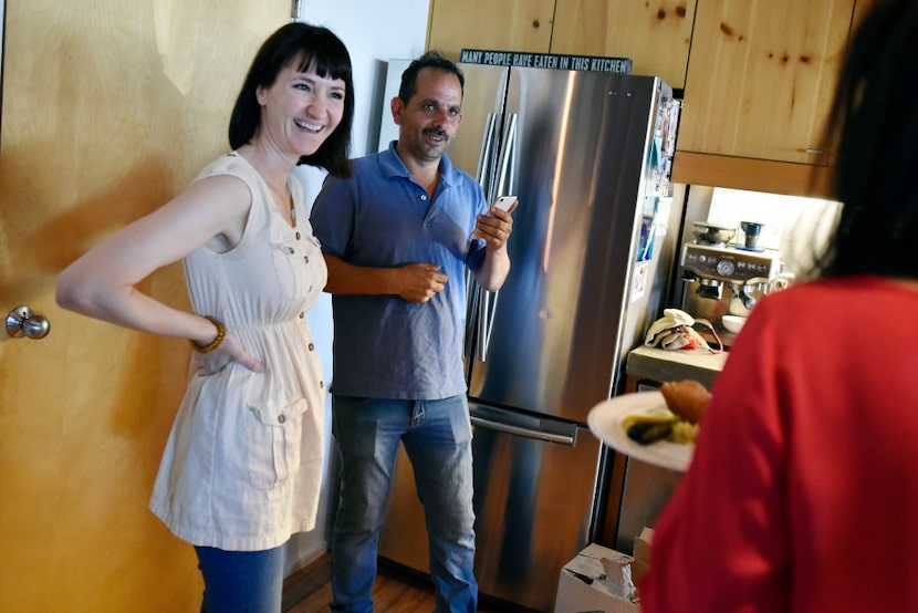 Organizer Olga Pope and Abdul Salam Aleid speak to guests during a fundraising dinner for...