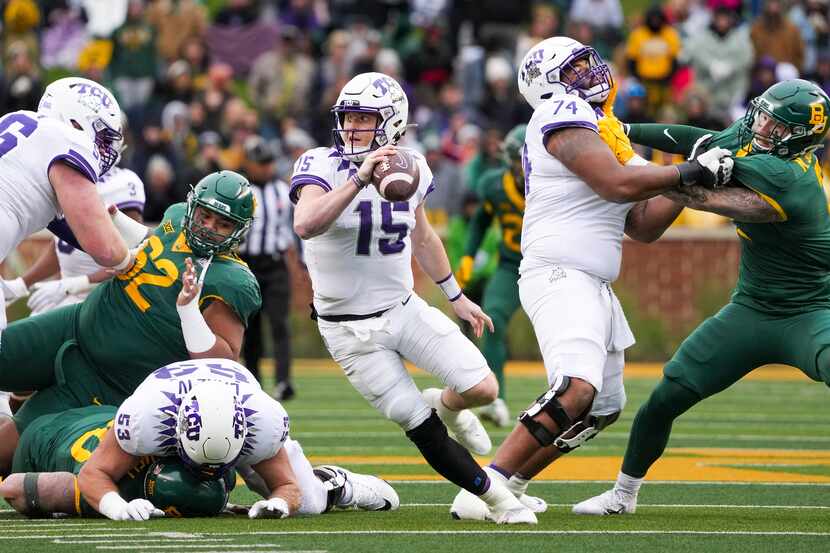 TCU quarterback Max Duggan (15) scrambles away from the Baylor pass rush during the second...