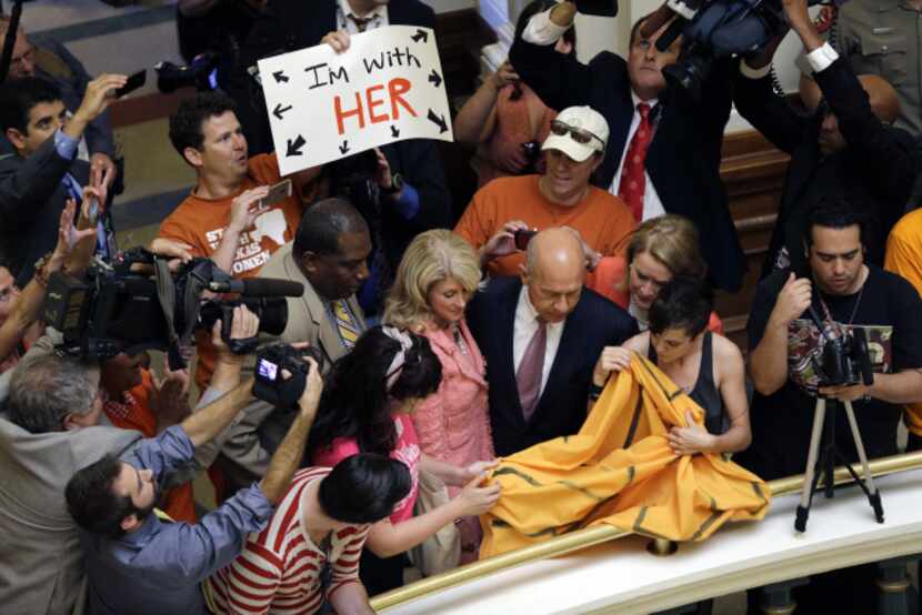 Sens. Royce West, Wendy Davis and John Whitmire walked into the Capitol rotunda as the...