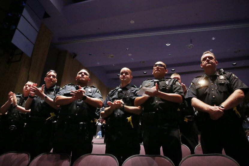 Dallas County Community College District police officers stand while being recognized during...