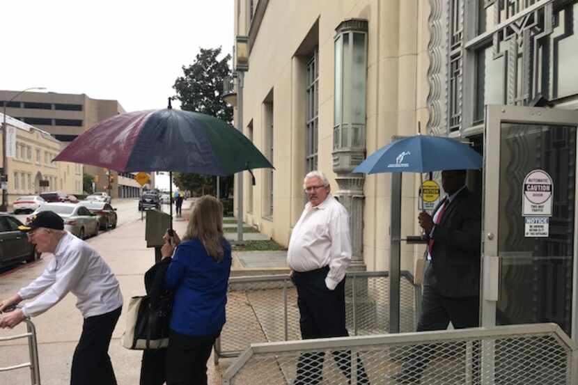 Glenn Eugene Halfin (center) exits the federal courthouse in Fort Worth on Wednesday after...