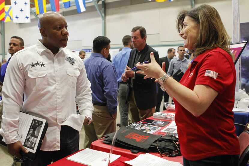 U.S. Marines veteran Illya Askew (left) speaks with Leigh Hassell of Southwest Airlines...