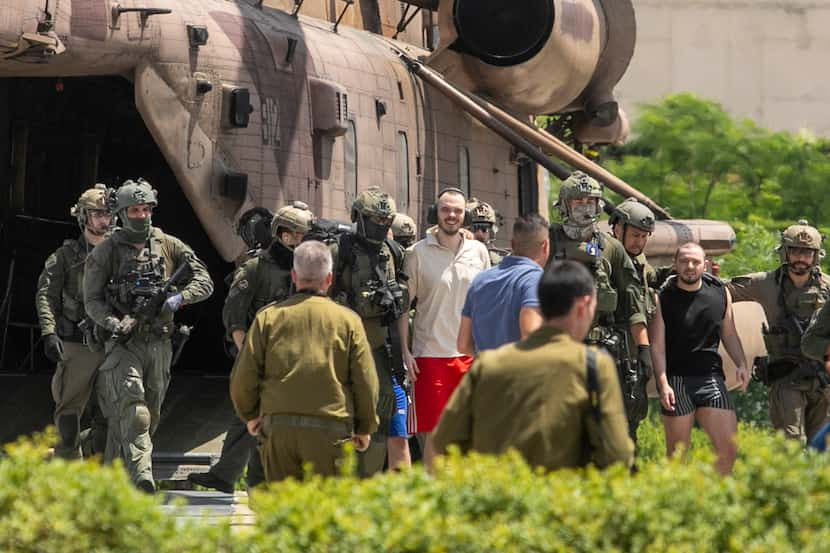 Andrey Kozlov, 27, left, and Almog Meir Jan, 21, two of four hostages just rescued, arrive...