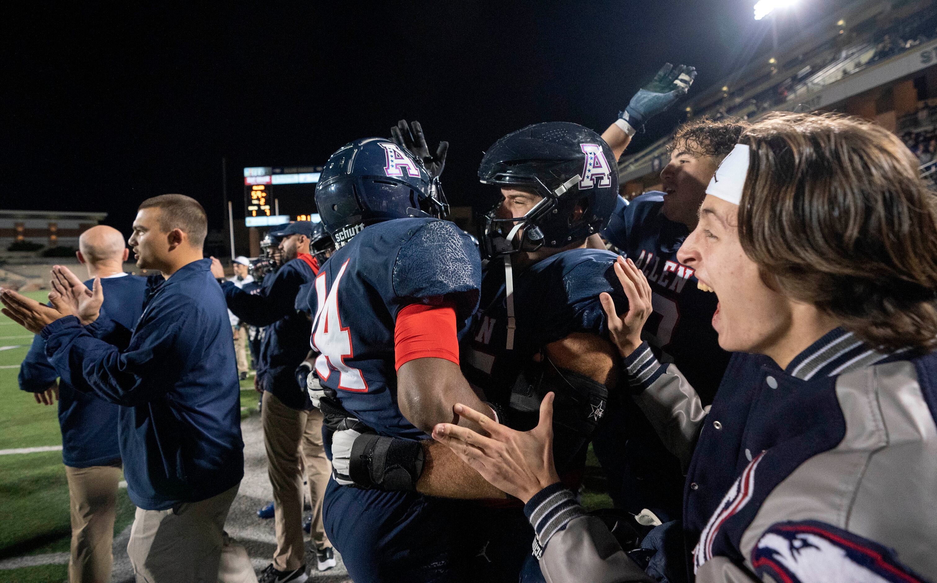 Allen players and coaches celebrate on the sidelines during the second half of a bi-district...