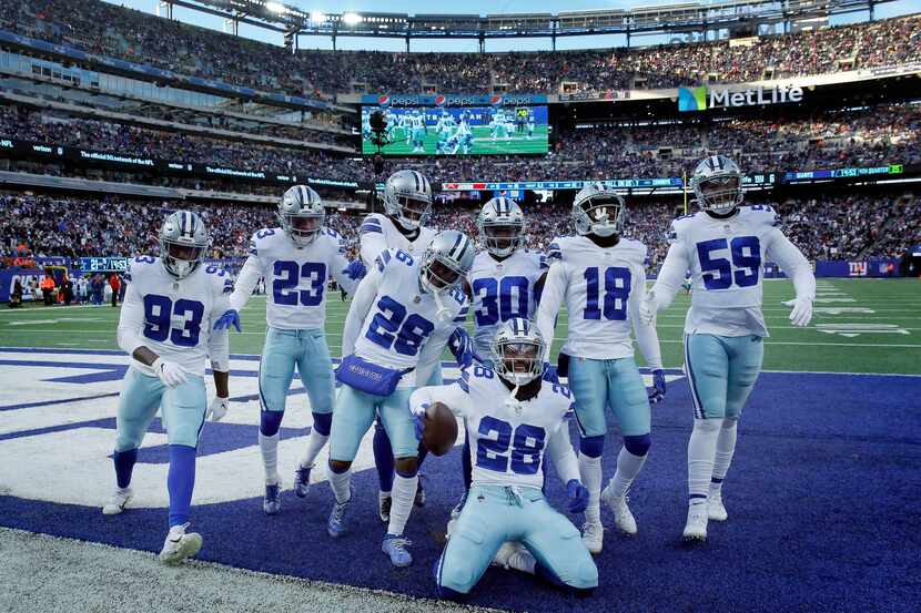 Dallas Cowboys safety Malik Hooker (28) and his defensive teammates pose for a photo after...
