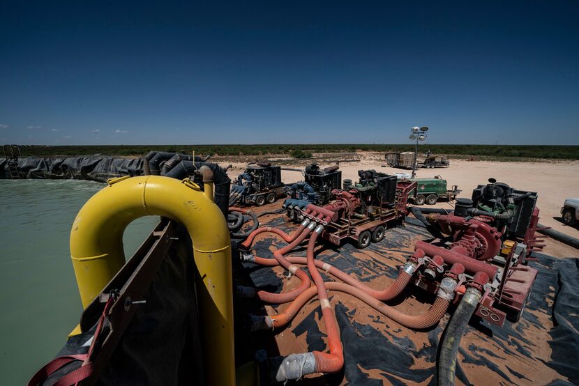 Workers extract oil from wells in the Permian Basin in Midland in 2018. High levels of...