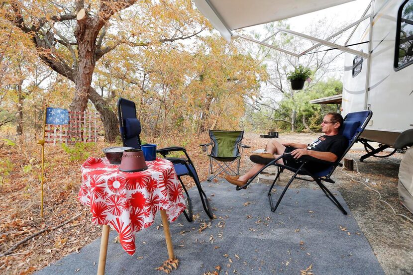 
Clarence Battaglia of Carrollton relaxes next to his trailer at Cedar Hill State Park....